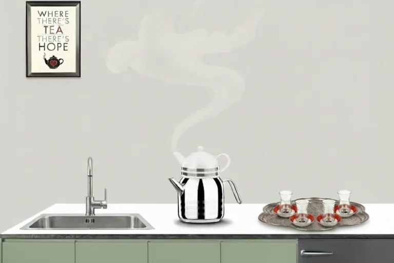 A teapot steaming on a kitchen counter with tea glasses and a framed quote on the wall